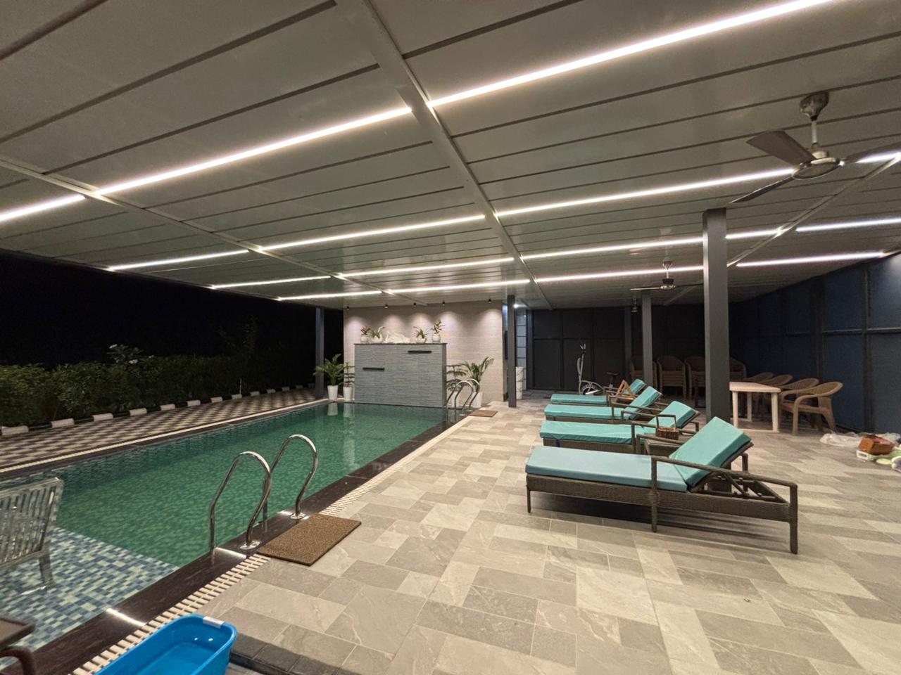 Rana’s Royal Villa lit up at twilight with infinity pool